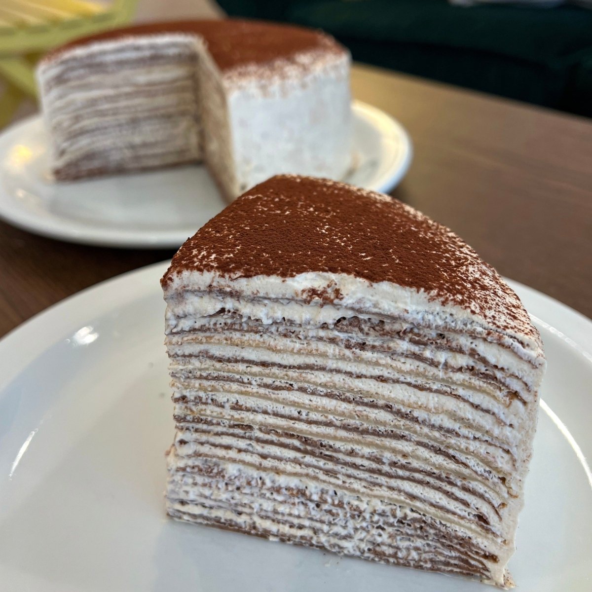 Layers of crepes, tiramisu filling with espresso shot and topped with cocoa powder at Nana's Crepreie