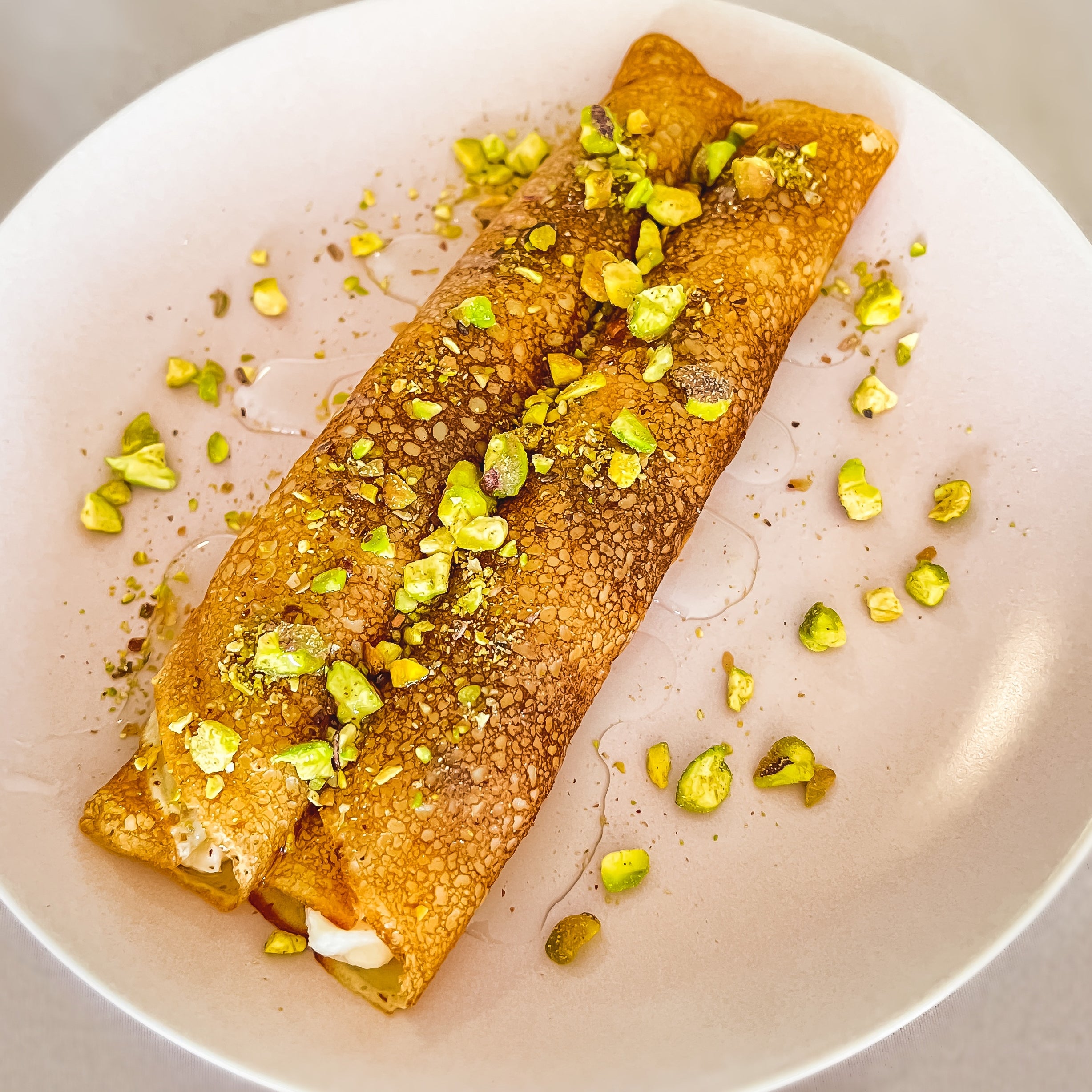 Nana's Creperie exclusive dessert crepe - Baklava Crepe with crushed Pistachio, Orange Blossom Syrup & Baklava traditional thickened cream.