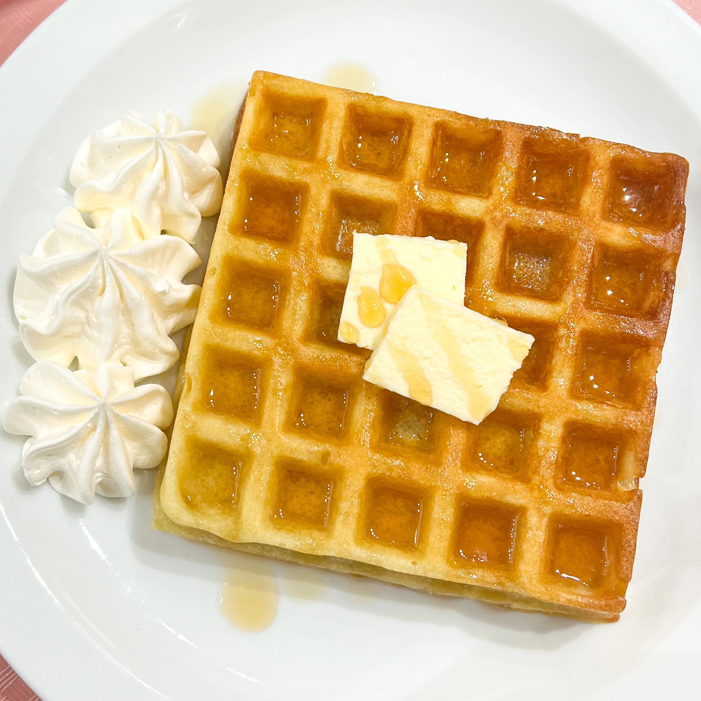 Classic waffle with butter, whipped cream and maple syrup at Nana's Creperie