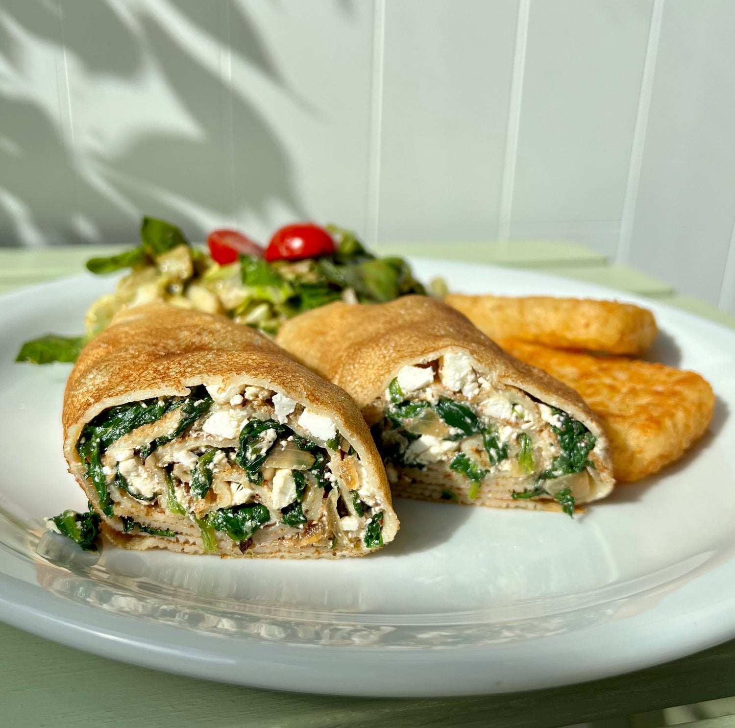 Spinach & Cheese crepe with hash browns and fresh salad at Nana's Creperie